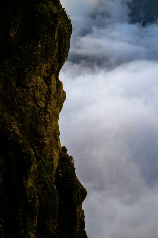 a very tall hill with a bunch of cloud in the sky