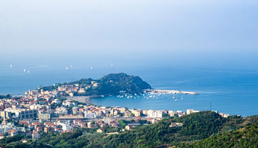 a city skyline overlooking the ocean and the beach