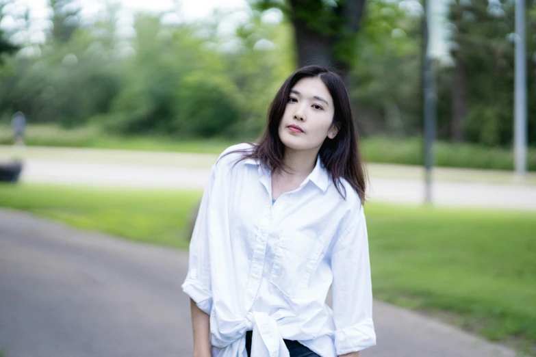asian woman in white shirt posing for the camera