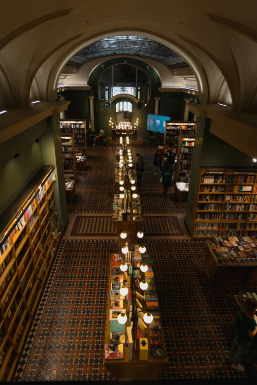 a group of people sit in an open area reading