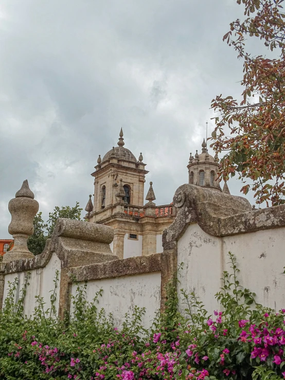 a very tall white stone building with a clock on top