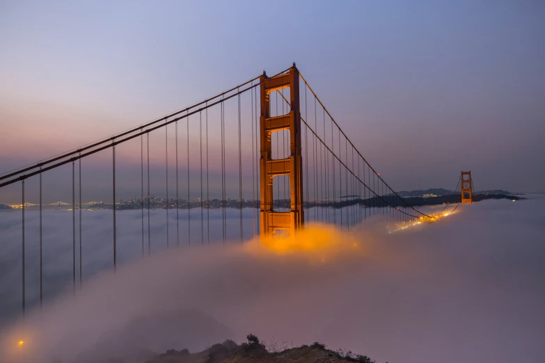 the golden gate bridge is surrounded by fog