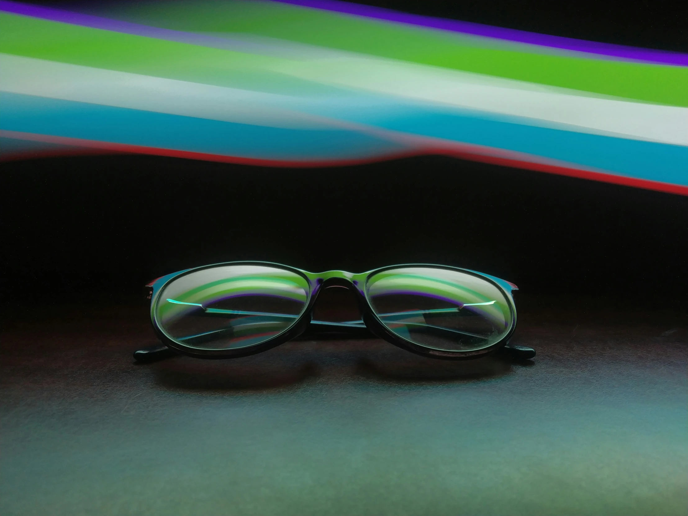 a pair of sunglasses resting on top of a black table