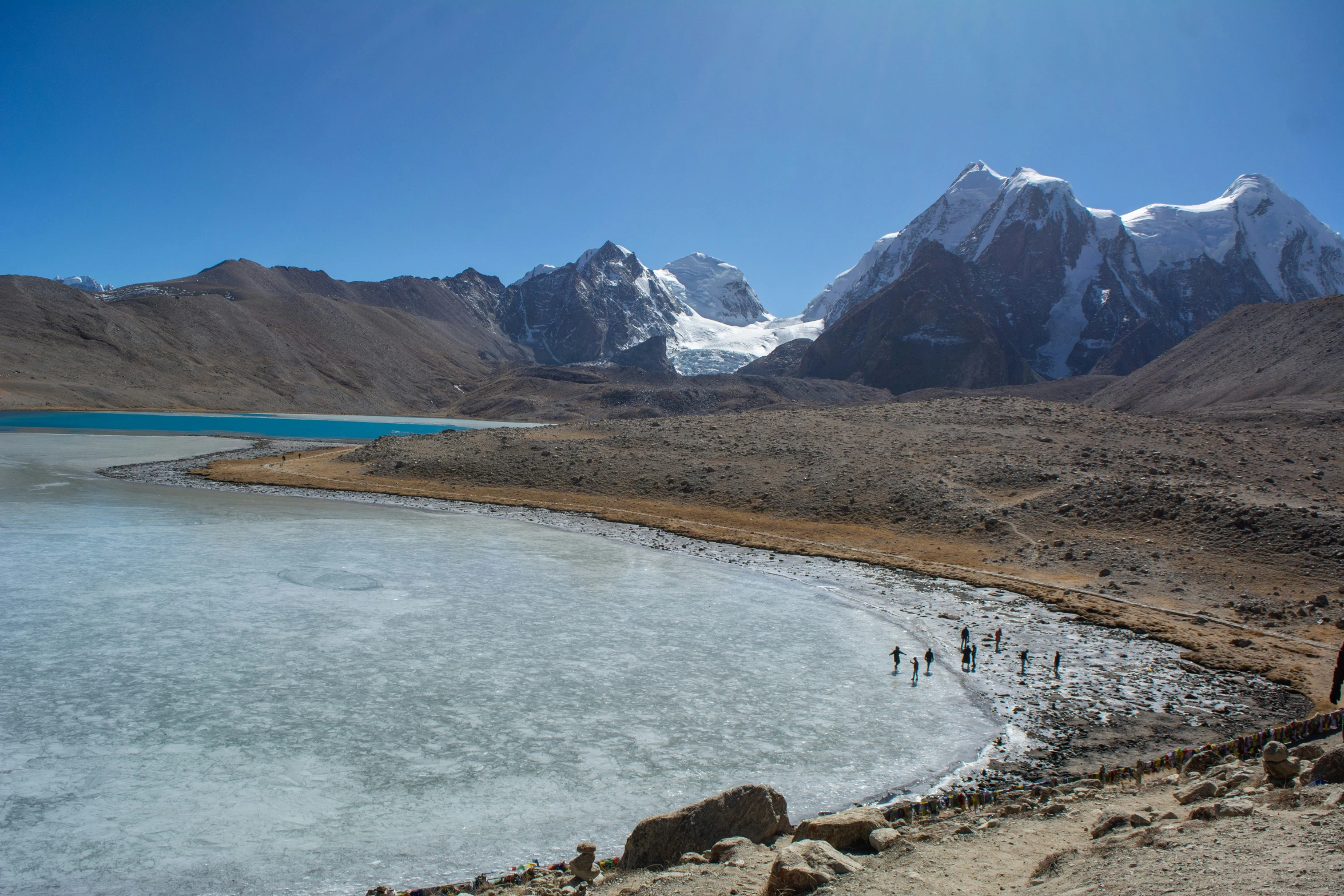 an image of people walking in the snow near water