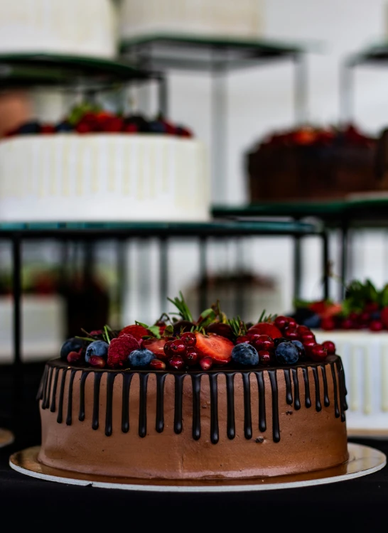 a chocolate cake with blueberries, strawberries and strawberrys