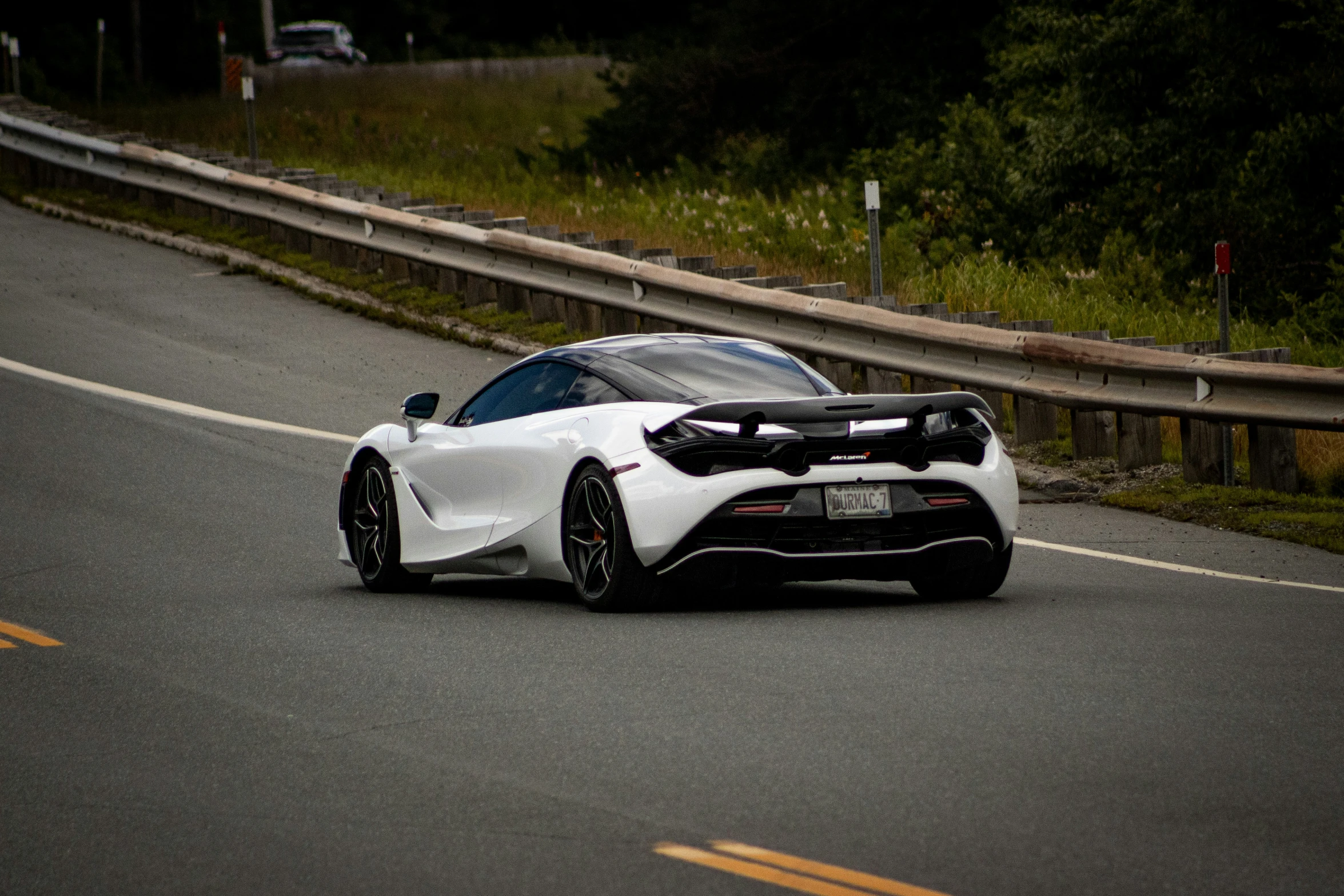 a car driving on the road near a curve