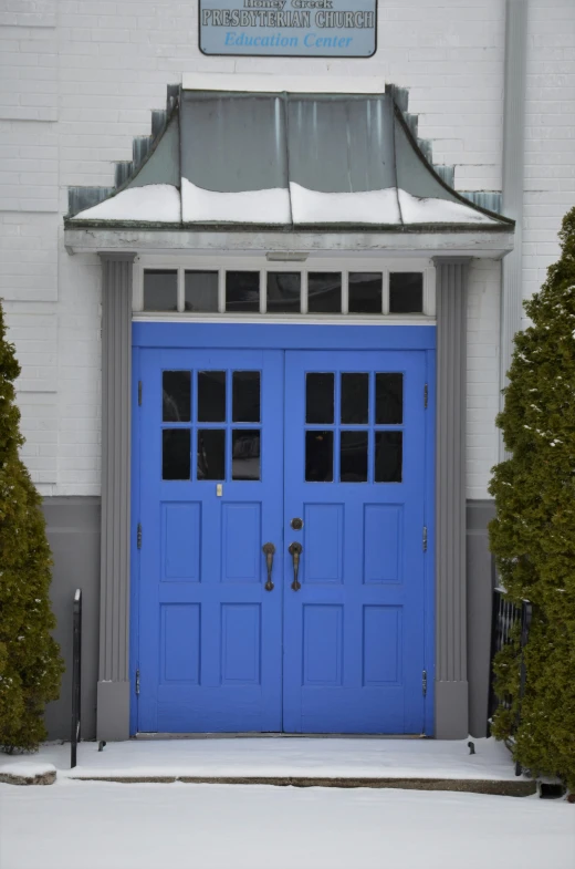 the blue doors are a good contrast to this house