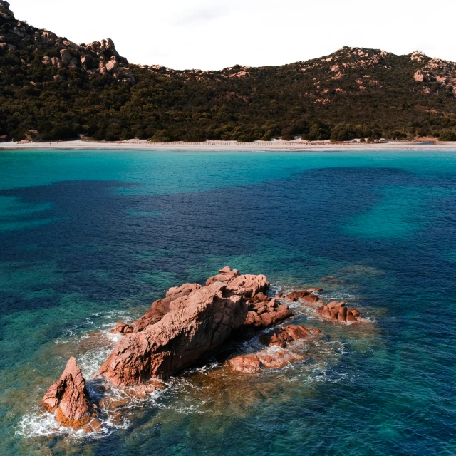 a rocky island floating on top of the ocean