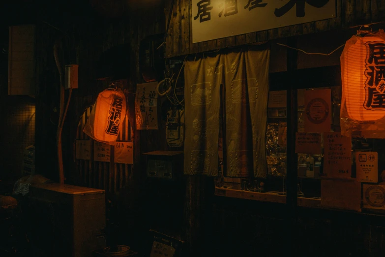 a dark room with lights on and various small red lanterns