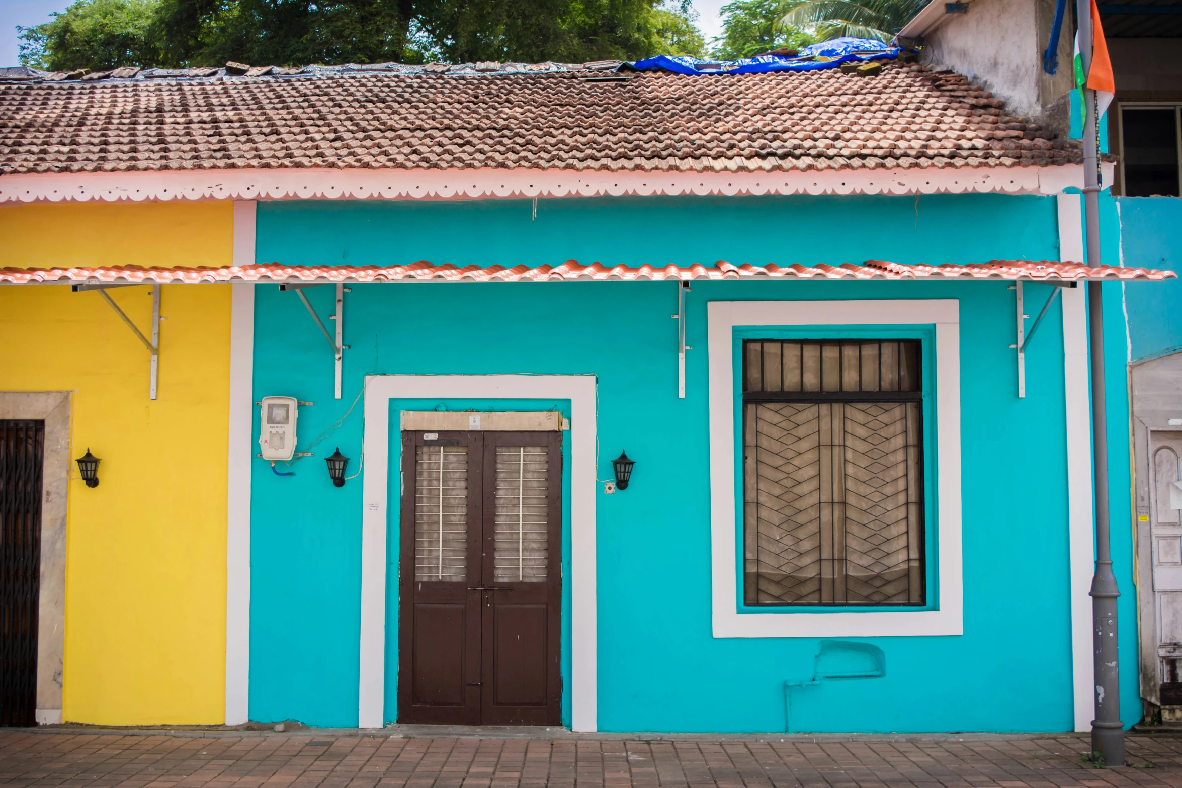 a house with a blue and yellow building in the background