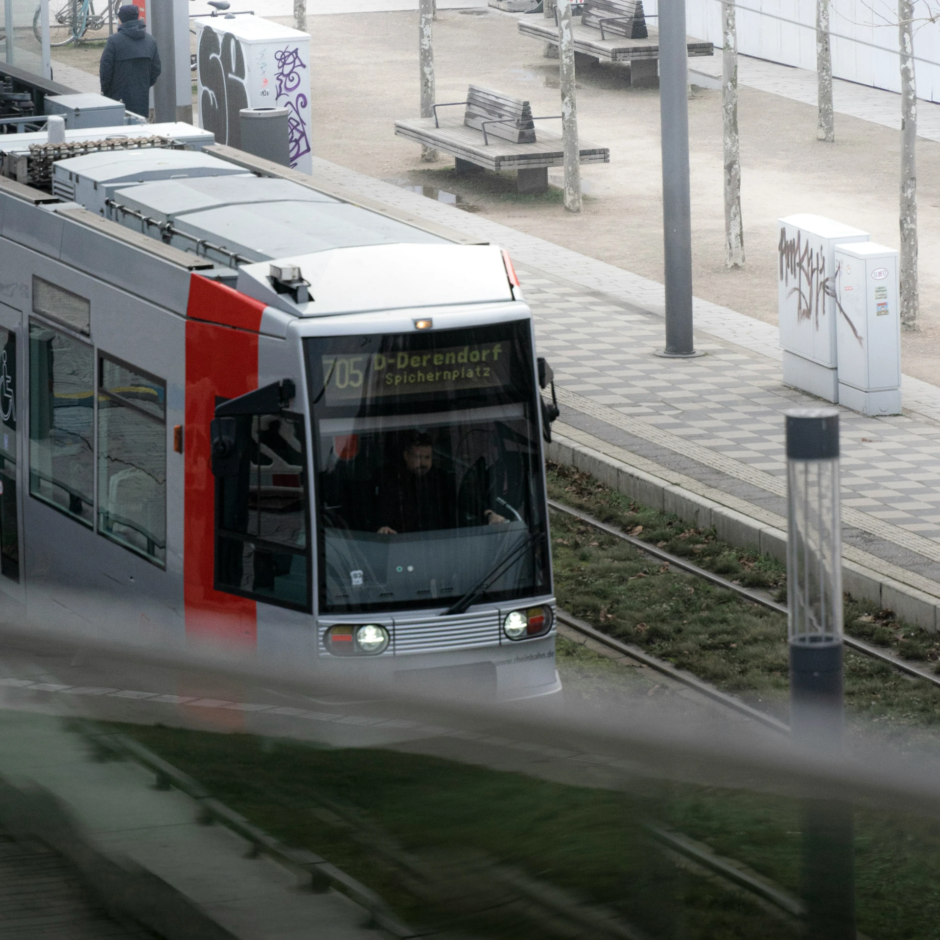 a passenger bus driving past a train station