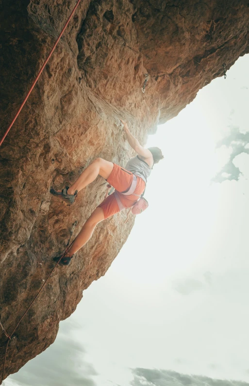 a man is climbing up and down on a rock