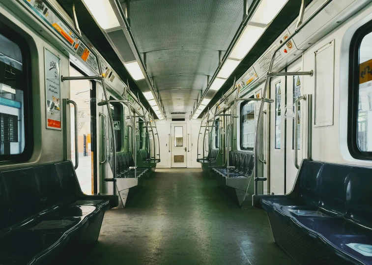 empty subway train with benches and mirrors