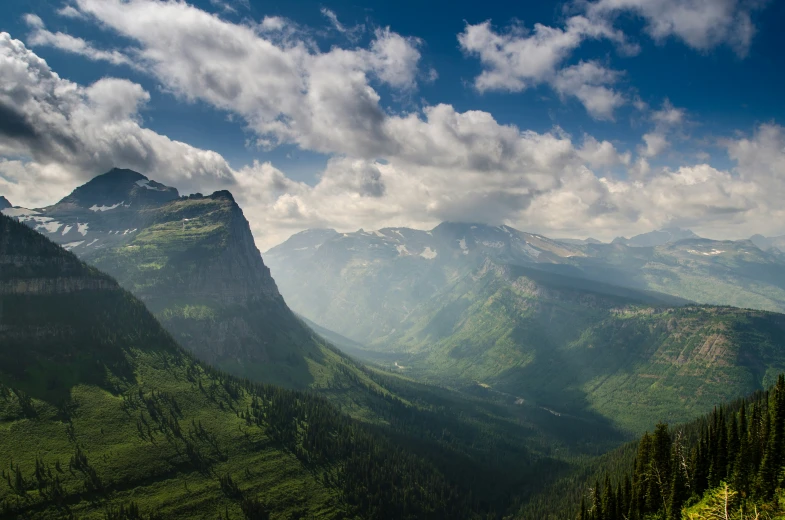 a beautiful mountain view with some trees and mountains