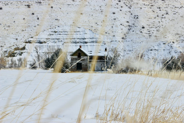 a snow covered hill with a building in the background