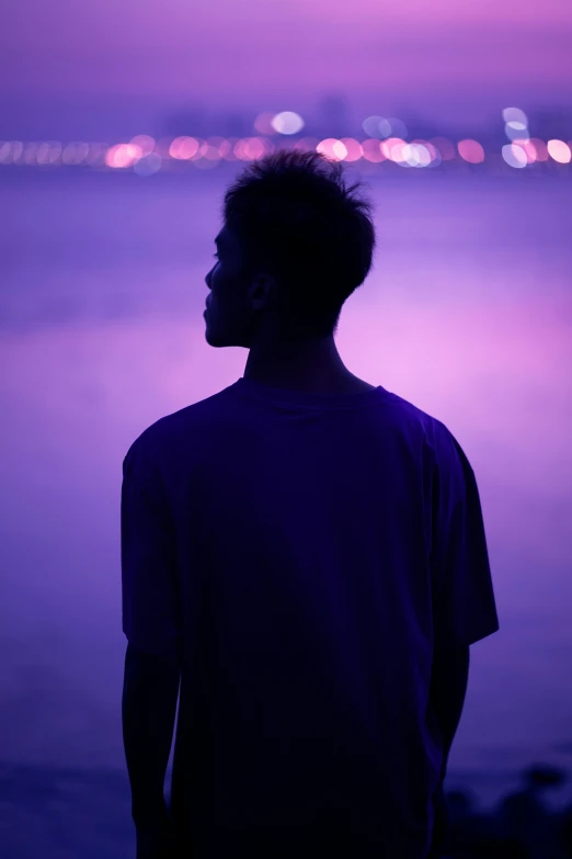 a person with the camera at dusk in front of a city