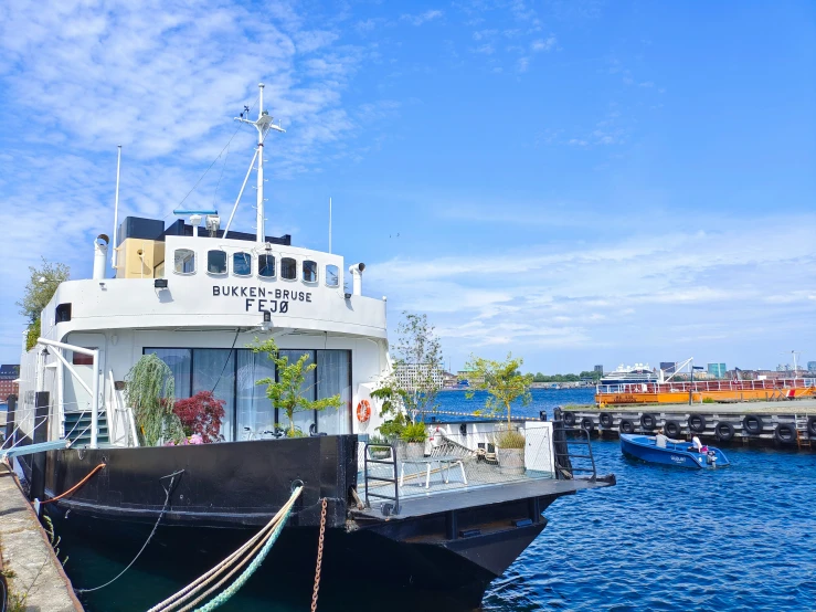 a boat sitting at the dock in a body of water