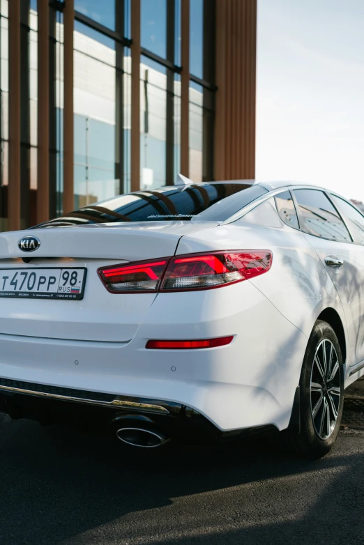 a white car parked near some tall building