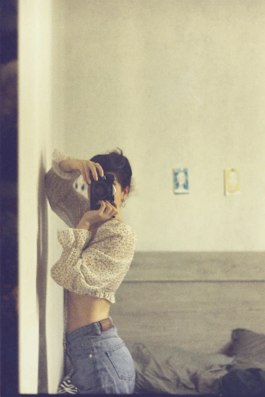 a woman taking a selfie in a bedroom