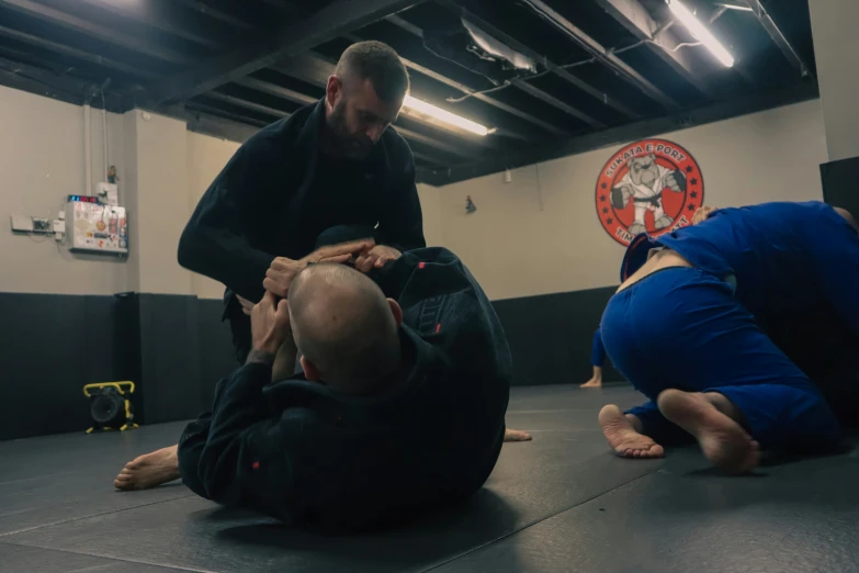 two adults doing a hand stand on one another