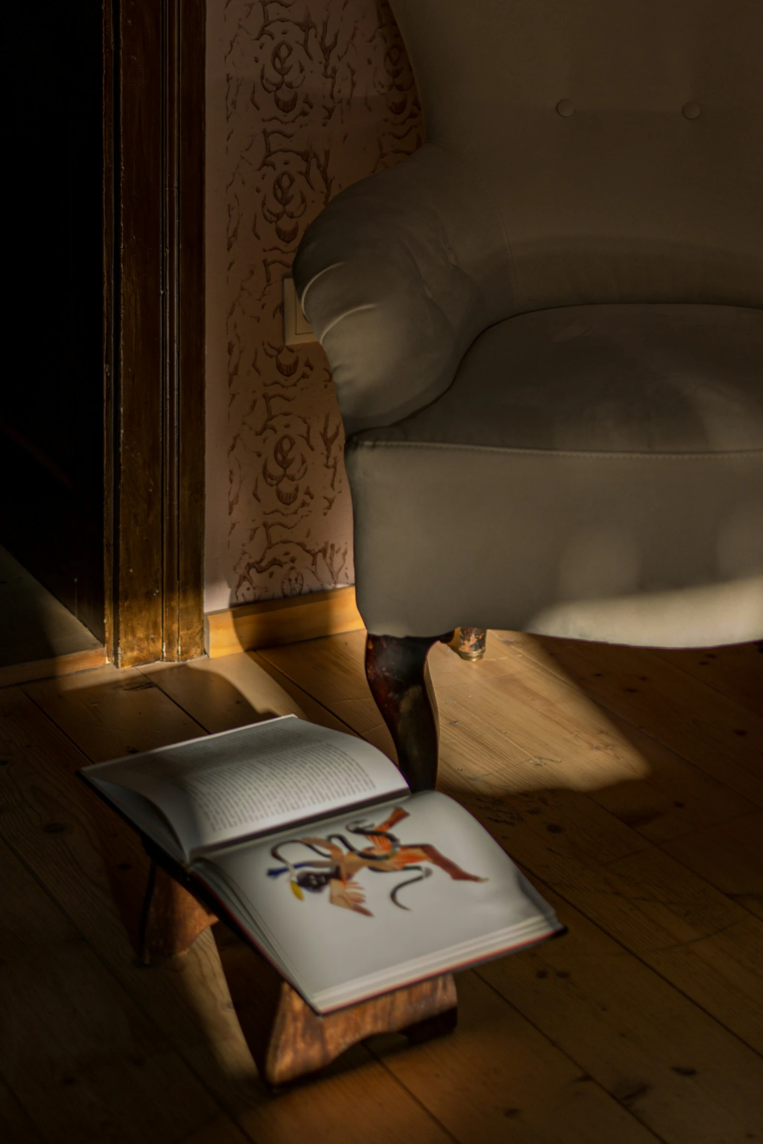 an open book sitting on top of a hard wood floor