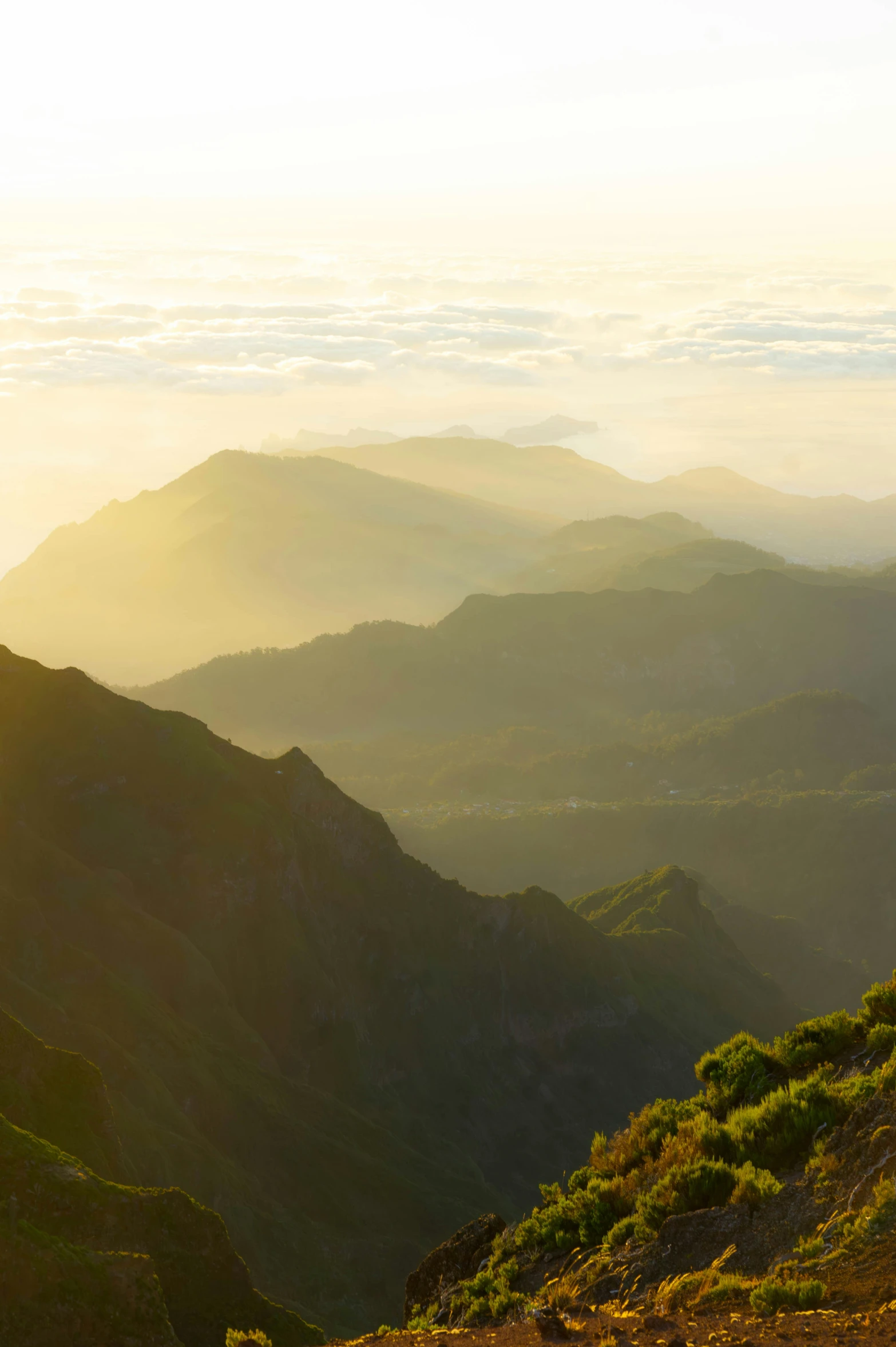 a po taken from a grassy hill top looking down at the mountains