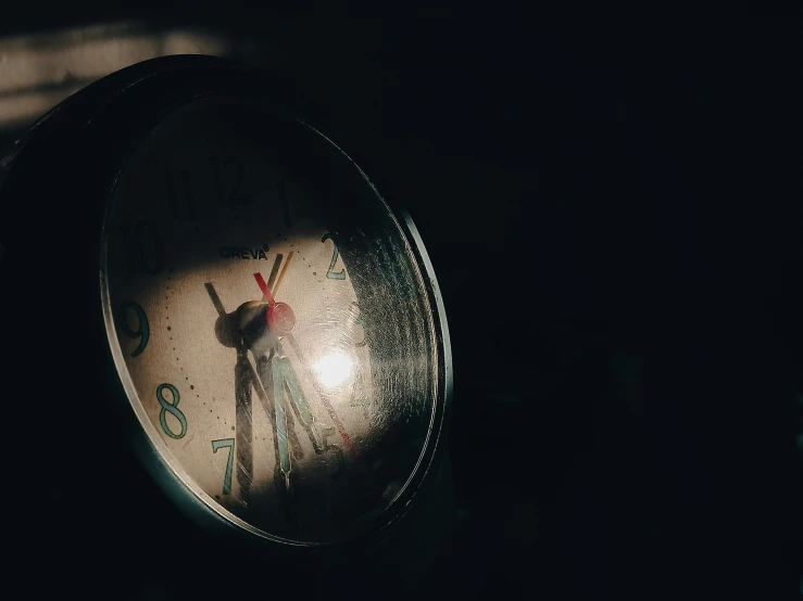 a round clock with several numbers sits on the floor