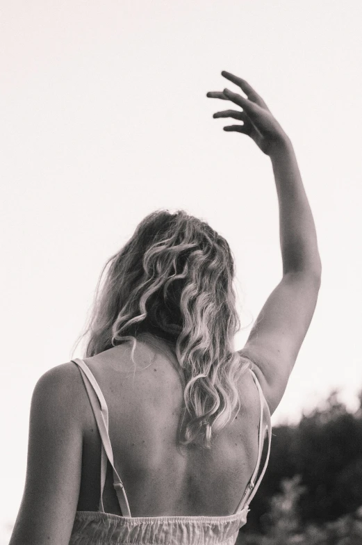 a black and white po of a woman with her arm up