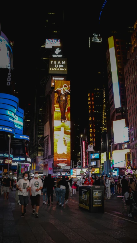 people are walking in a street at night