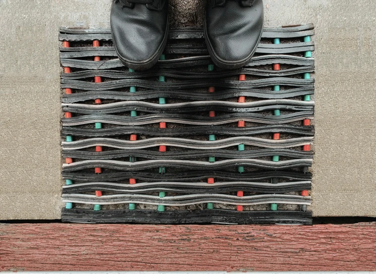 a pair of shoes sits on top of a patterned carpet