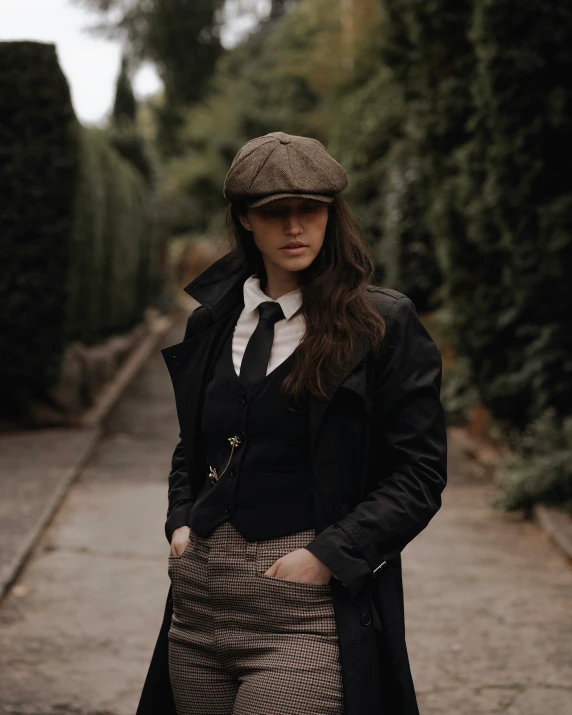 a woman dressed in brown is wearing a cap