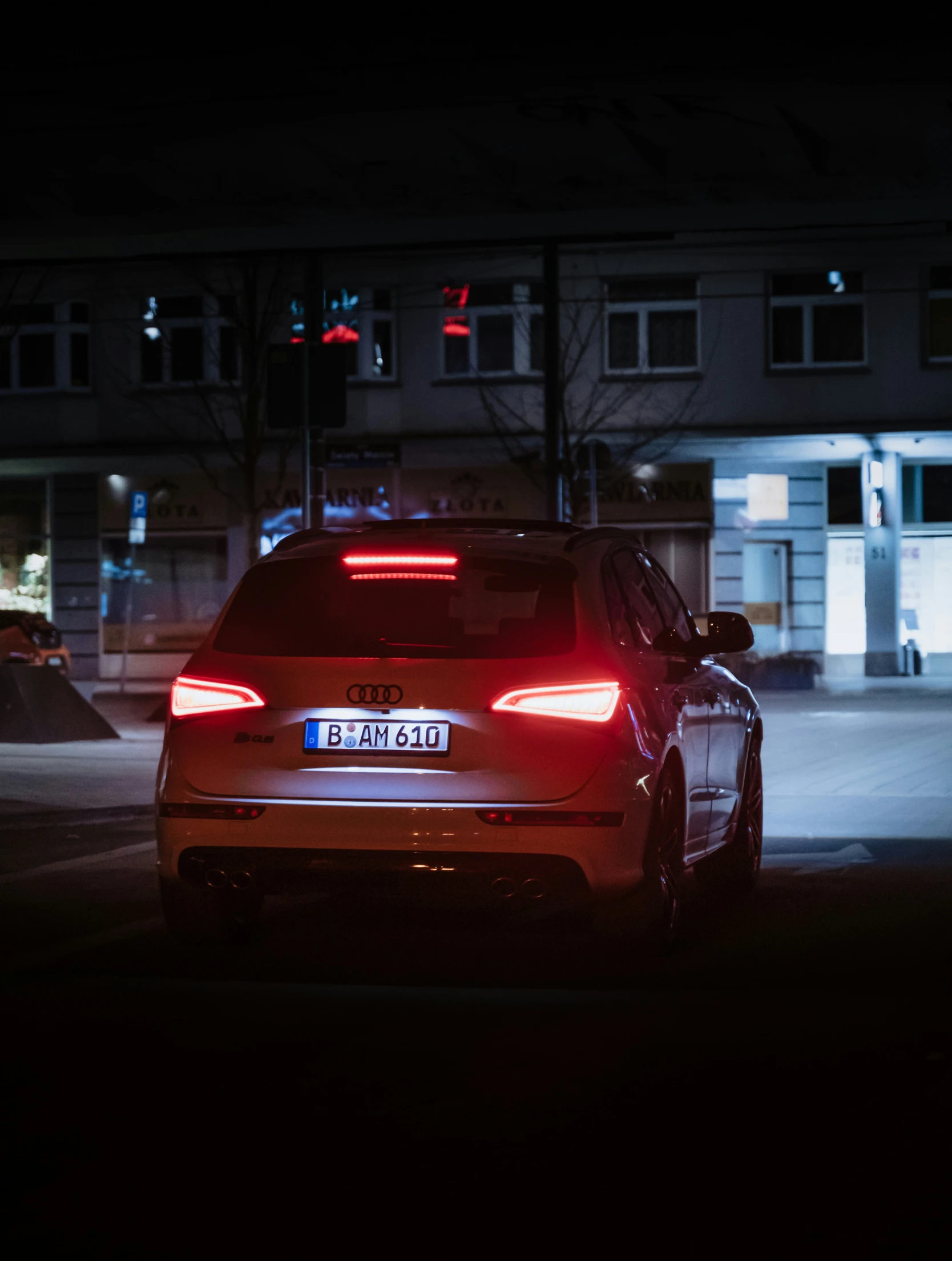 a car parked on the side of a road at night