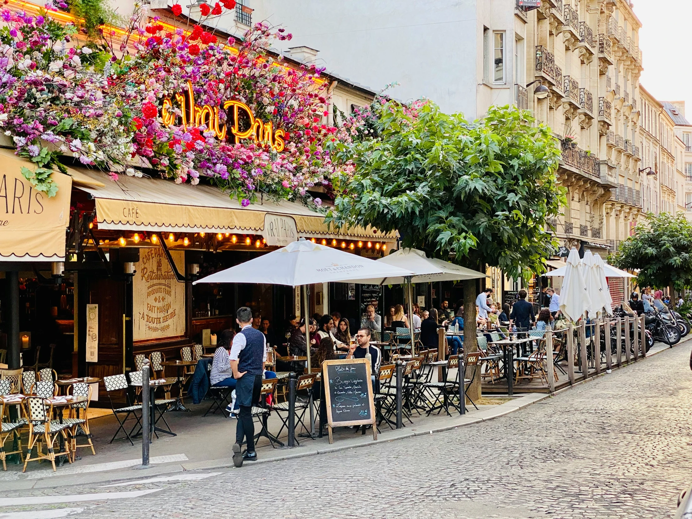 this is a city street with people standing around and on bicycles