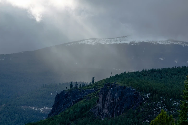 a tall mountain in the background covered with trees