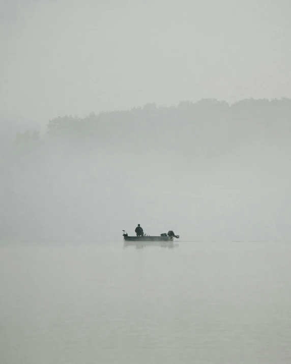 two people in the water are rowing a small boat