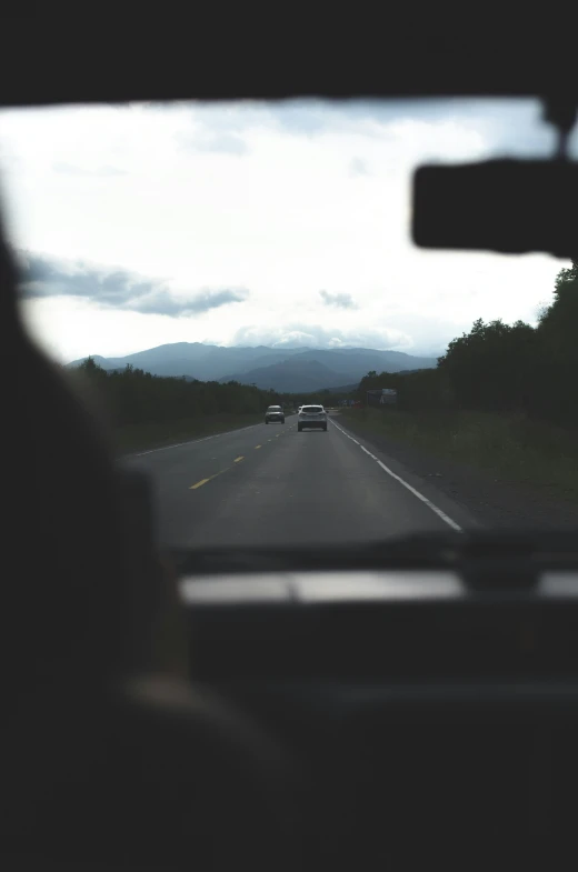 a person taking a picture of the view of a road