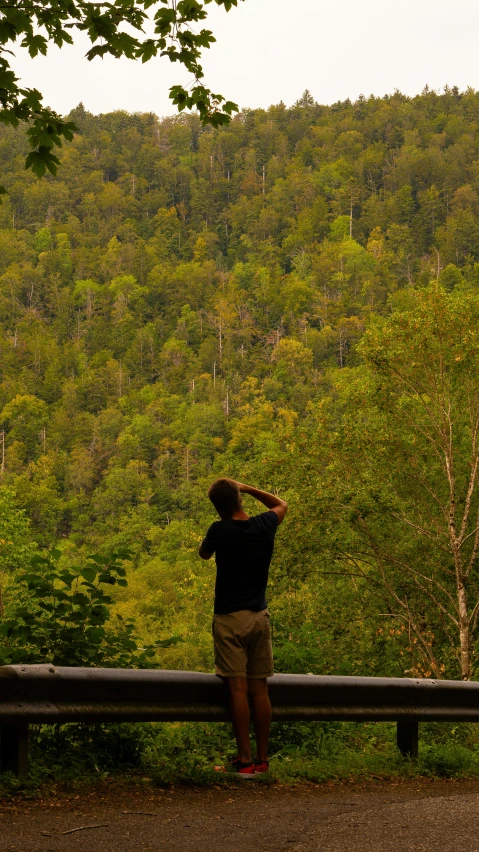 a man looks out over the view from a bench
