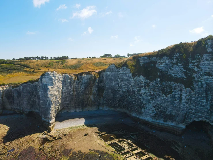 an aerial view of a hill near some cliffs