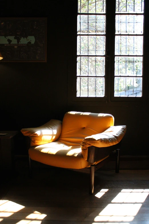 a living room with the sunlight shining on the floor and windows