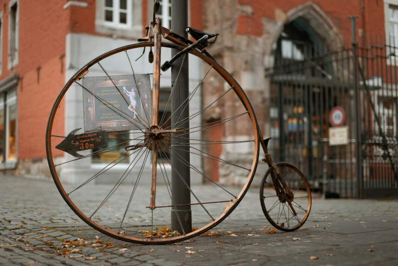 a bike locked to a pole with no wheels