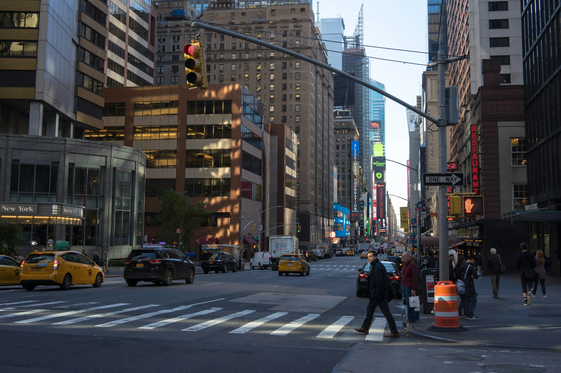 a busy city street with lots of people walking