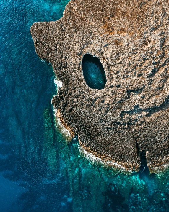 a cliff formation and an aerial view of it with water around