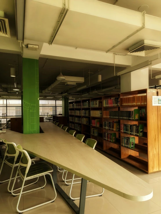 a liry room with an arrow shaped table and a bookshelf