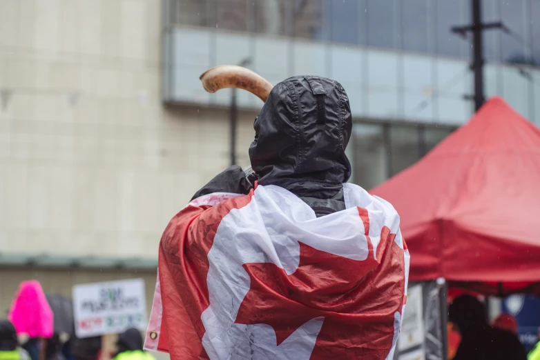 there is a man that is wearing a canada flag