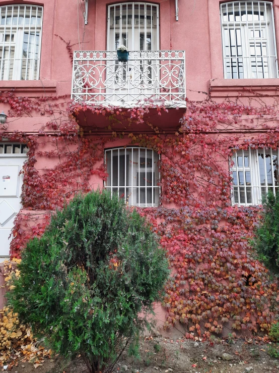 a red brick building with white balconies and a balcony