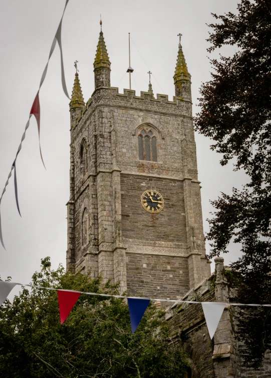 a castle type building with clocks on the top of it