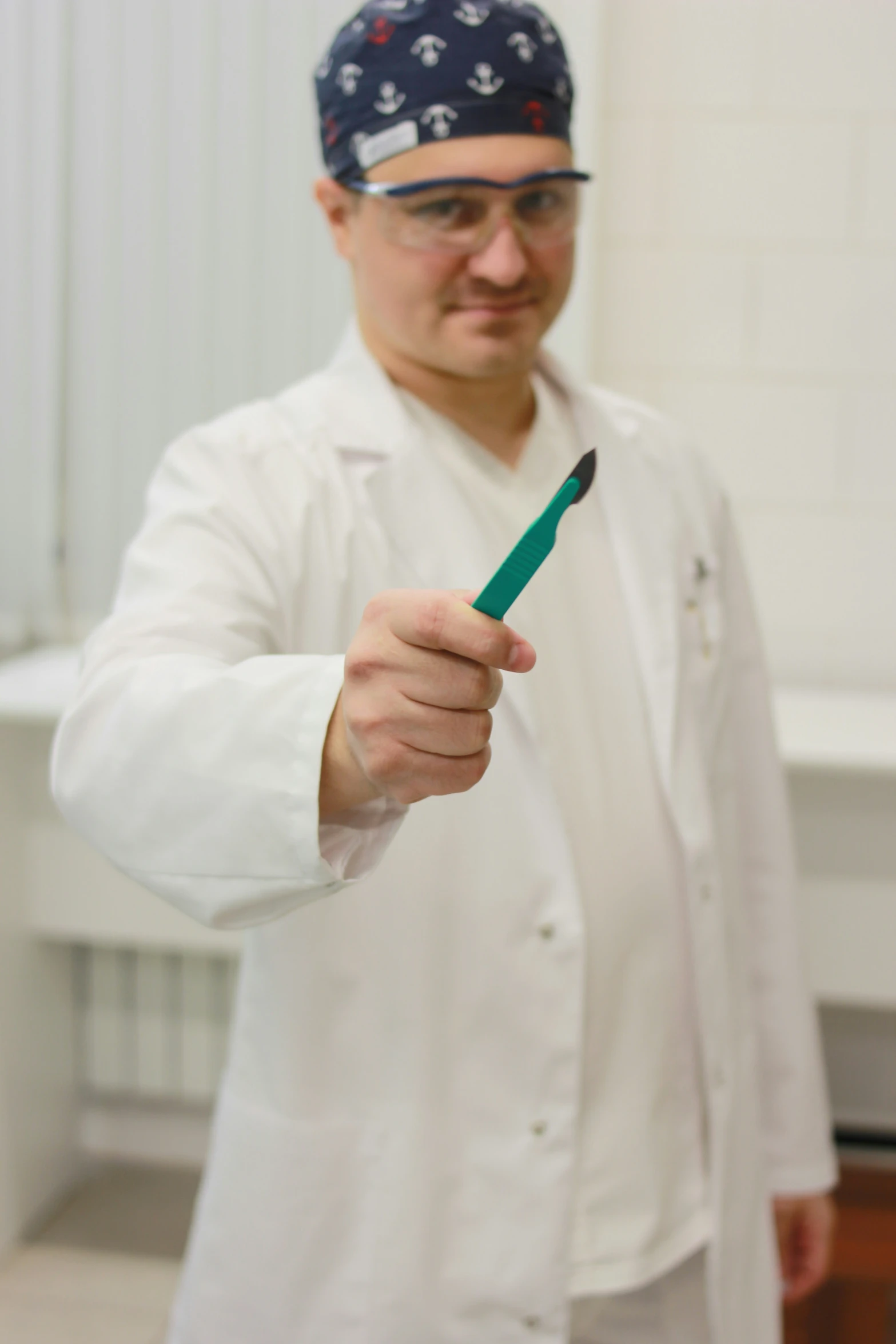 a man wearing glasses is holding a toothbrush in his hand