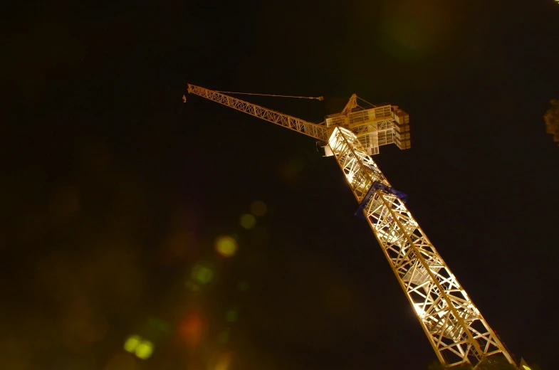 a tall metal tower lit up by lights at night