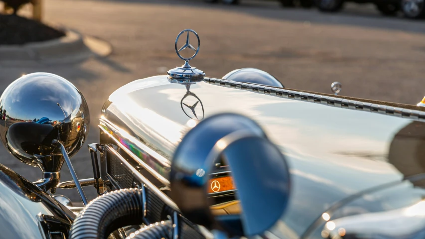 the hood ornament on an old style mercedes motorcycle