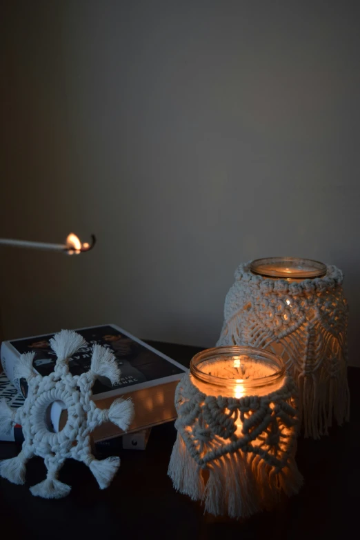 a table topped with a lit candle and a mirror